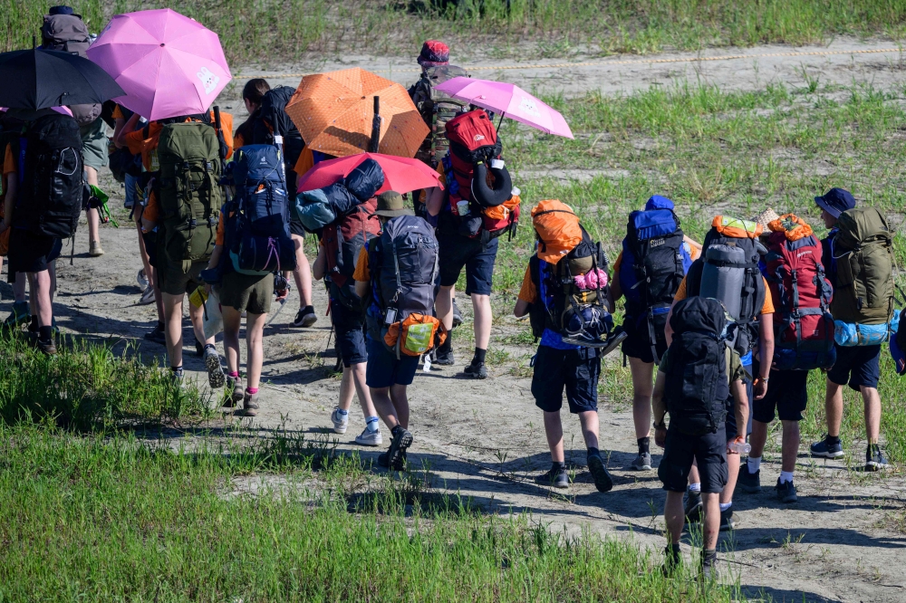 Scouts prepare to leave the World Scout Jamboree in Buan, North Jeolla province on August 8, 2023.  Tens of thousands of scouts were being evacuated from their problem-plagued South Korean campsite on August 8 ahead of a typhoon, as the scout chief said the challenges were unprecedented in a century of global jamborees