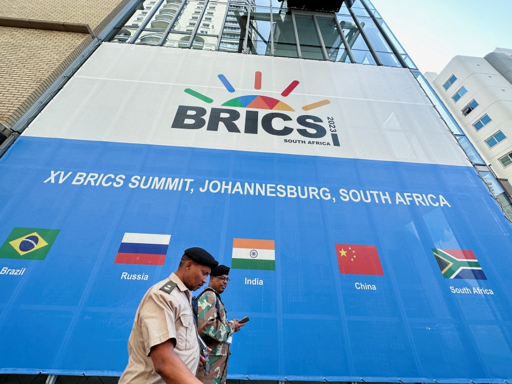 People walk past the Sandton Convention Centre, which will host the upcoming BRICS Summit, in Johannesburg, South Africa. - Reuters