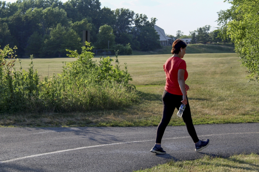 Teo Filip walks while listening to music through her headphones at Eldridge Park, in Elmhurst, Ill., on June 28, 2022. (Yana Paskova/The New York Times)