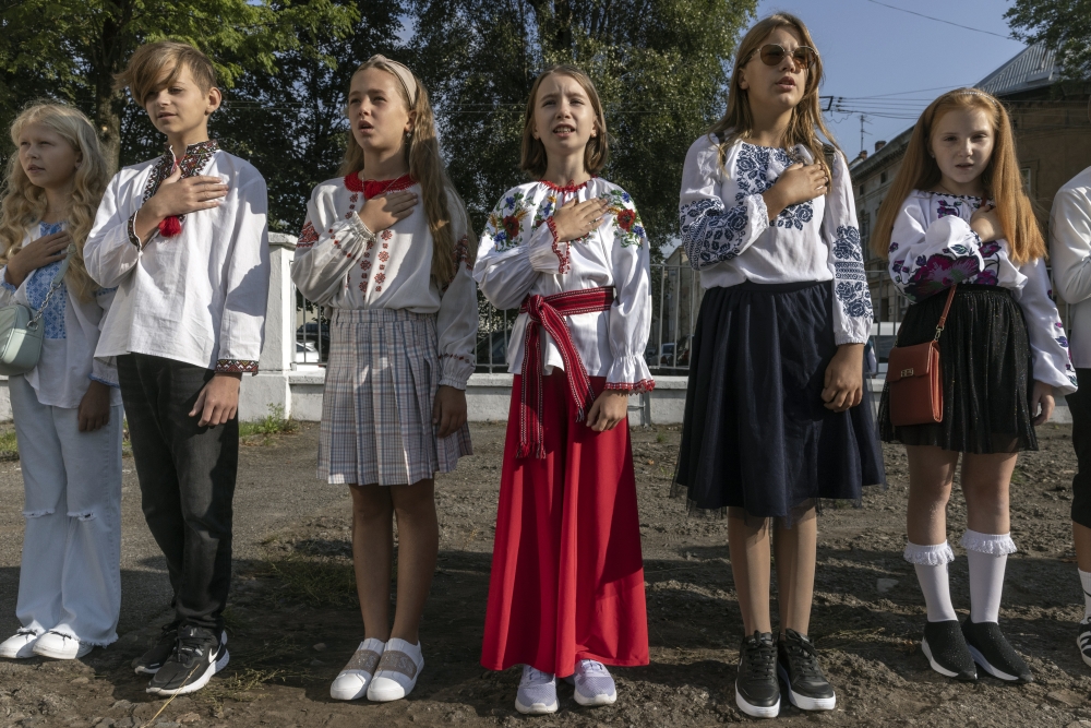 Students sing the Ukrainian national anthem on a school playground in Lviv on Friday, Sept. 1, 2023, the first day of the school year. (David Guttenfelder/The New York Times)