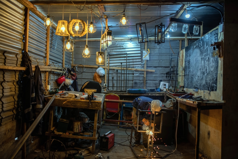 A welding workshop in Goma, one of many small businesses that stand to benefit from greater availability of electricity.  (Moses Sawasawa/The New York Times)