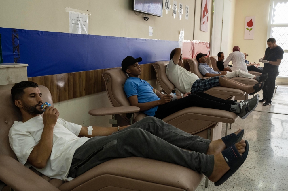 Men donate their blood for victims of a deadly earthquake, at the Marrakesh Regional Blood Transfusion Center, in Morocco, on Sunday, Sept. 10, 2023. (Nariman El-Mofty/The New York Times)
