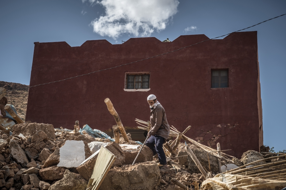 A man from Ait Abderahman’s family digs the rubble for his relatives who are still missing in the rubble of their house in Douar Tnirt village in the Atlas Mountains in the hard-hit Al Haouz province, Morocco, on Sunday, September 10, 2023. (Sergey Pono