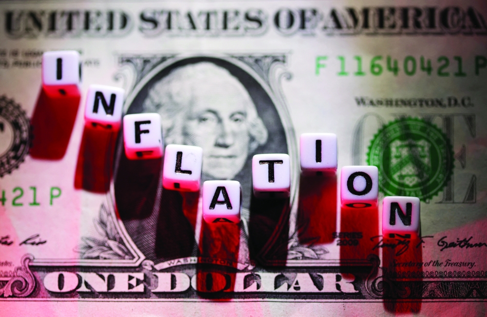 Illustration shows plastic letters arranged to read 'Inflation' are placed on US dollar banknote. — Reuters