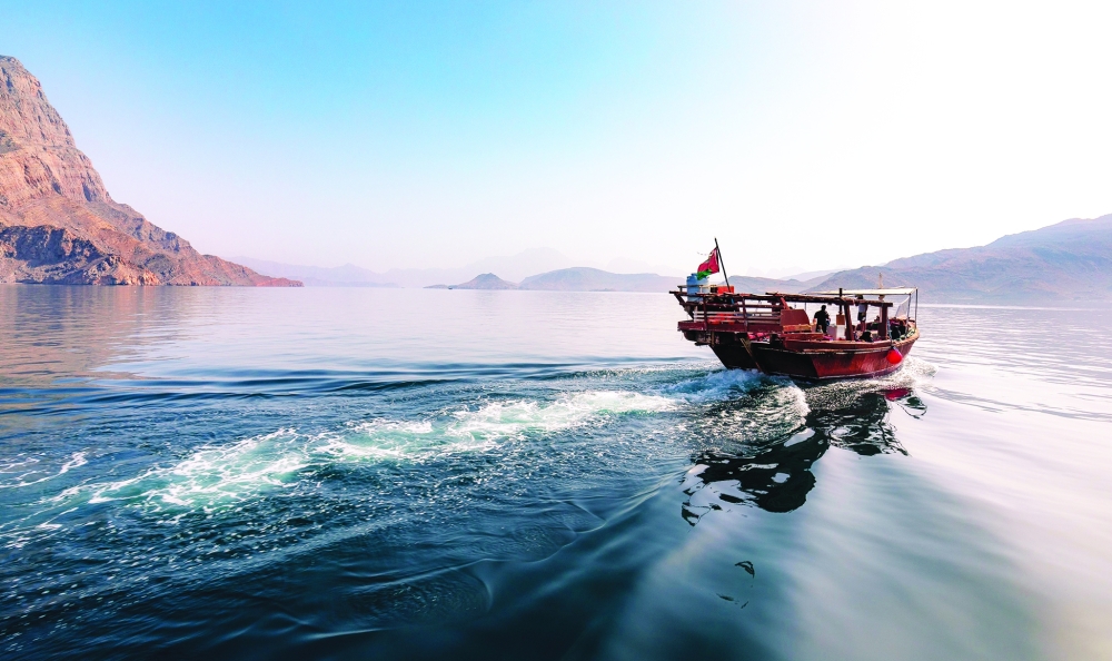 A dhow cruise is seen in the fjords of Musandam in Oman.