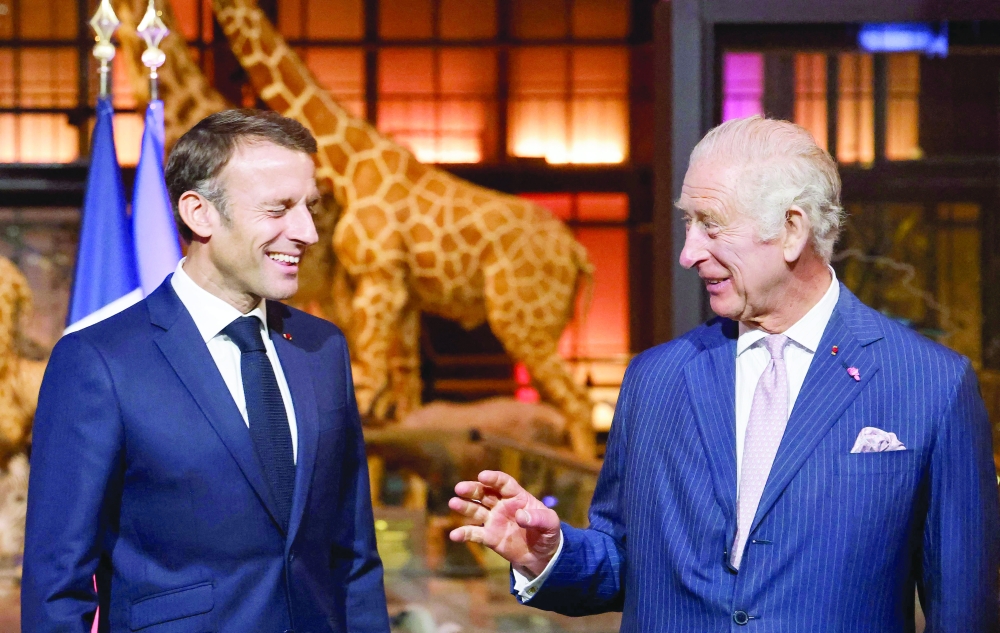 French President Emmanuel Macron and Britain's King Charles III during their visit to the Museum of Natural History to meet business leaders and talk about biodiversity, in Paris. - AFP