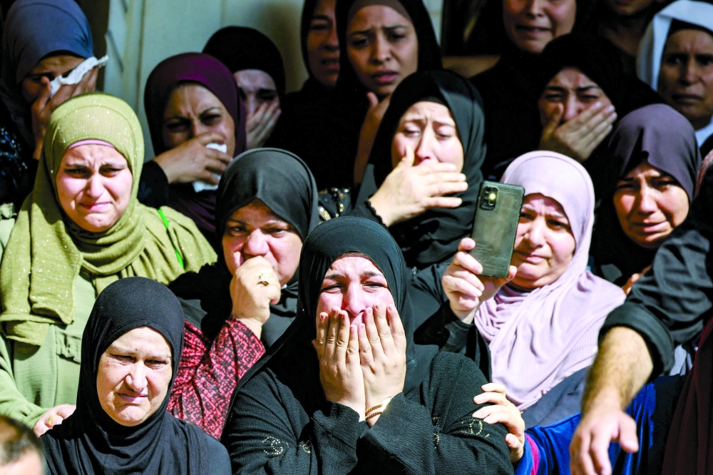 Women mourn the death of 18-year-old Abdullah Abu Hassan, a local fighter from the Al Quds Brigades armed wing, killed earlier in clashes with Israeli troops when they raided the village of Kafr Dan in the northern West Bank, during his funeral procession in the village of Alyamon west of Jenin. - AFP