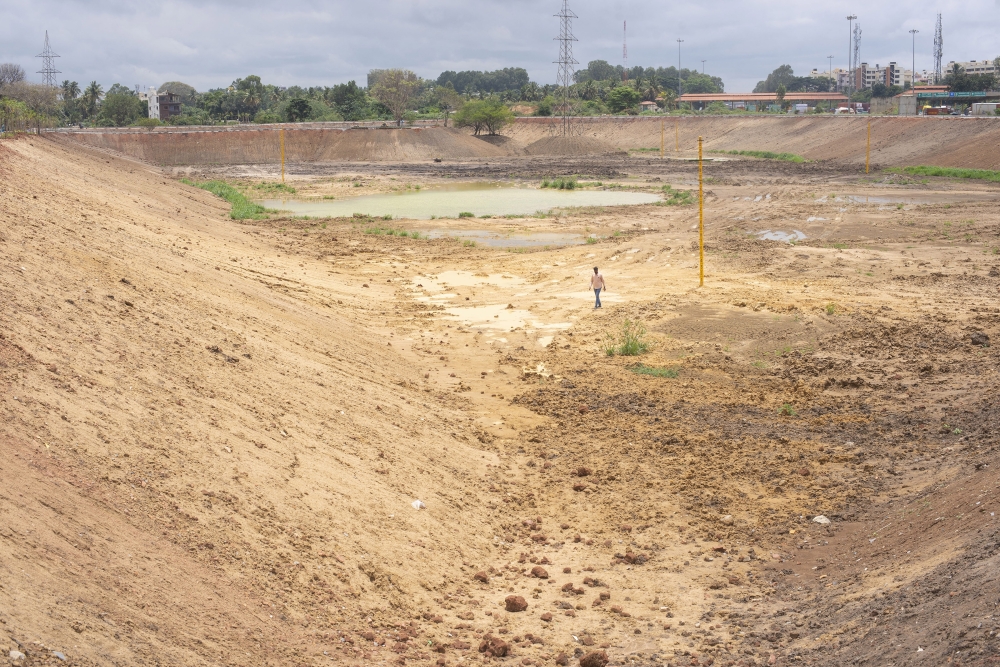 Anand Malligavad, a mechanical engineer known as “Lake Man,” surveys one of his reclamation projects, Doddathoguru Lake, in Bengaluru, India, July 27, 2023. (Priyadarshini Ravichandran/The New York Times)