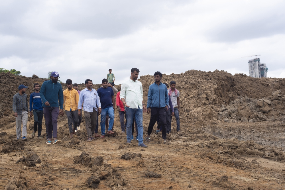 Anand Malligavad, a mechanical engineer known as “Lake Man,” with members of his lake reclamation team at a project in Bengaluru, India, July 28, 2023. (Priyadarshini Ravichandran/The New York Times)