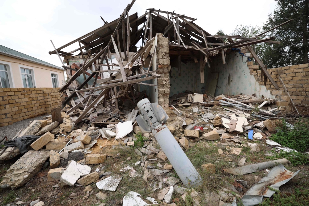 This photo shows a missile in the ground next to a house destroyed during the 2020 war between Azerbaijan and Armenian separatists, in the town of Terter, on September 24, 2023. 
