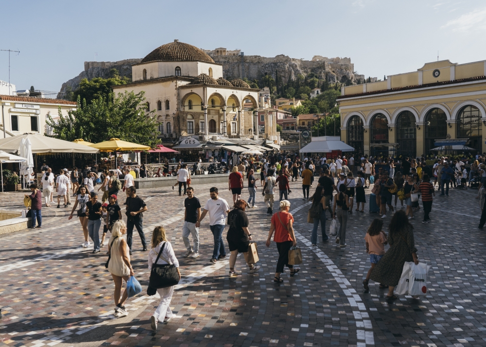 Tourists and locals at Monastiraki square in Athens, on Sept. 9, 2023. (Marco Arguello/The New York Times)