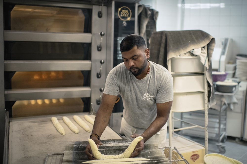 Tharshan Selvarajah, the 2023 winner of the “Grand Prize of the Traditional French Baguette,” at his bakery, “Au levain des Pyrénées”, in Paris on Sept. 14, 2023.  (Dmitry Kostyukov/The New York Times)
