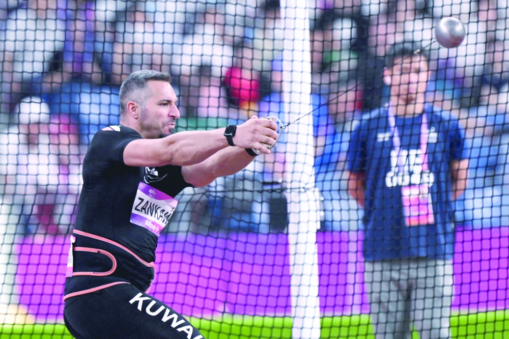  Kuwait's Ali Zankawi throw the hammer injuring an official during the men's hammer throw final Games in Hangzhou.—AFP

