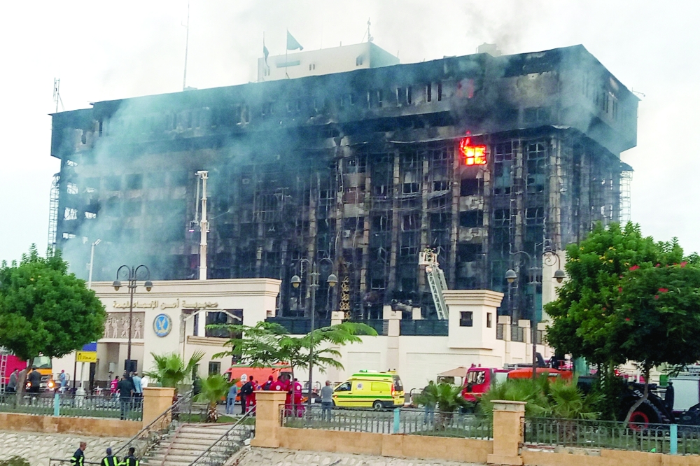 Firefighters try to extinguish a fire at a police headquarters in Ismailia. — AFP 