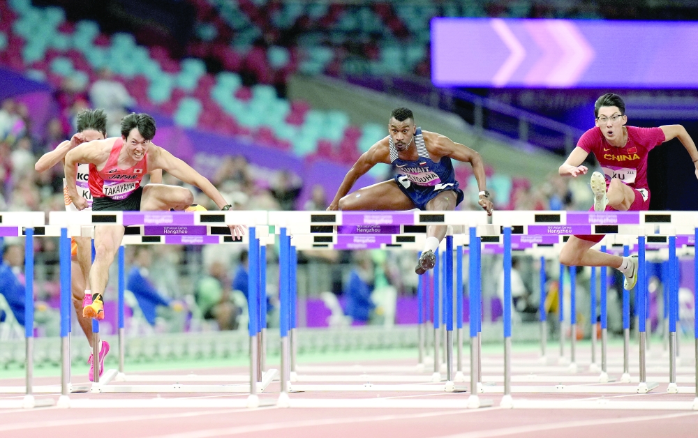 Athletes in action during the men's 110m hurdles final at Olympic Sports Centre Stadium, Hangzhou. -- Reuters
