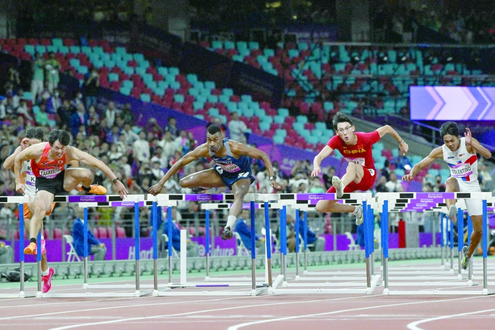 Kuwait's Yaqoub al Youha sprints to victory in the men's 110m hurdles final during the 2022 Asian Games in Hangzhou. -- AFP