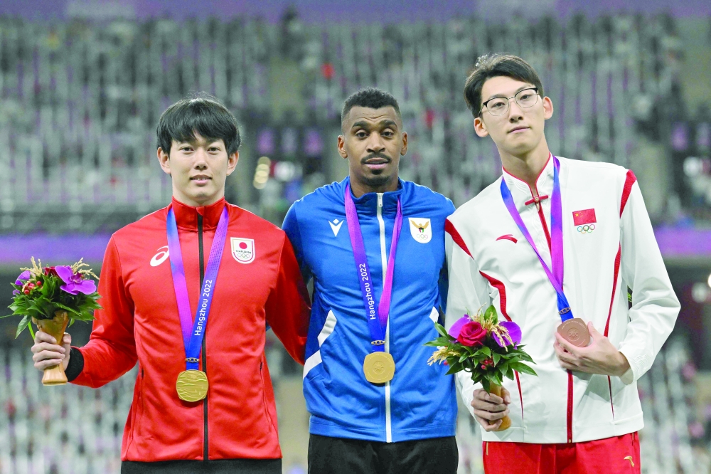 (L-R) Men's 110m hurdles gold medallists Japan's Shunya Takayama and Kuwait's Yaqoub al Youha and bronze medallist China's Xu Zhuoyi celebrate on the podium. -- AFP

