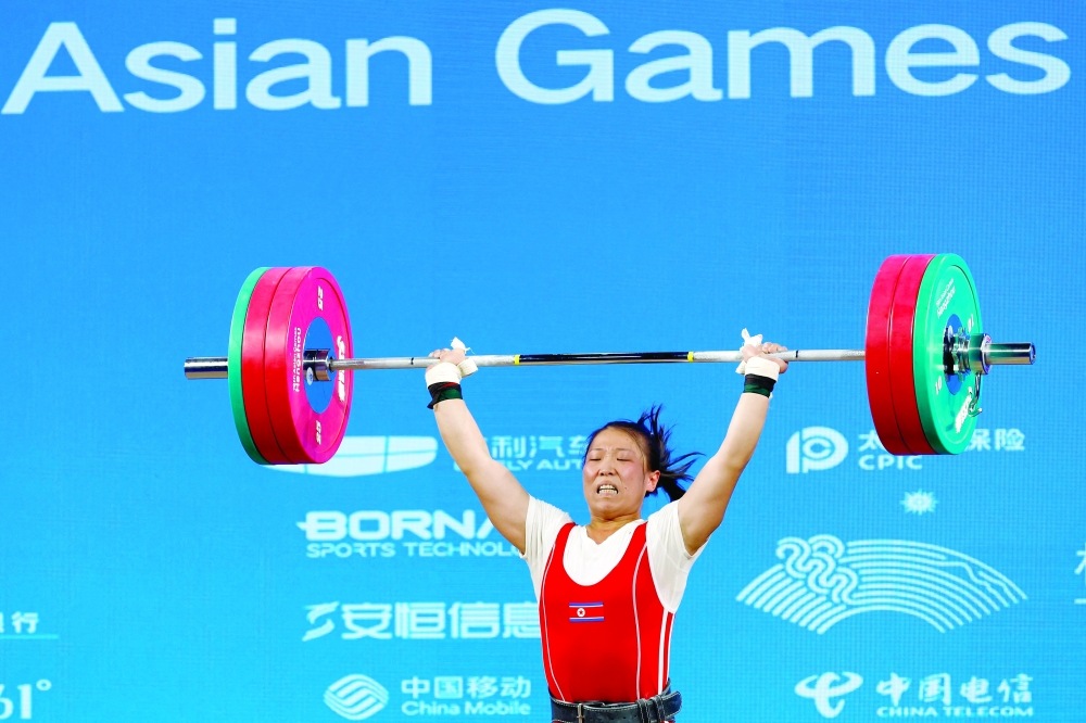 North Korea's Rim Unsim in action during the women's 64 kg Group A weightlifting event. -- Reuters
