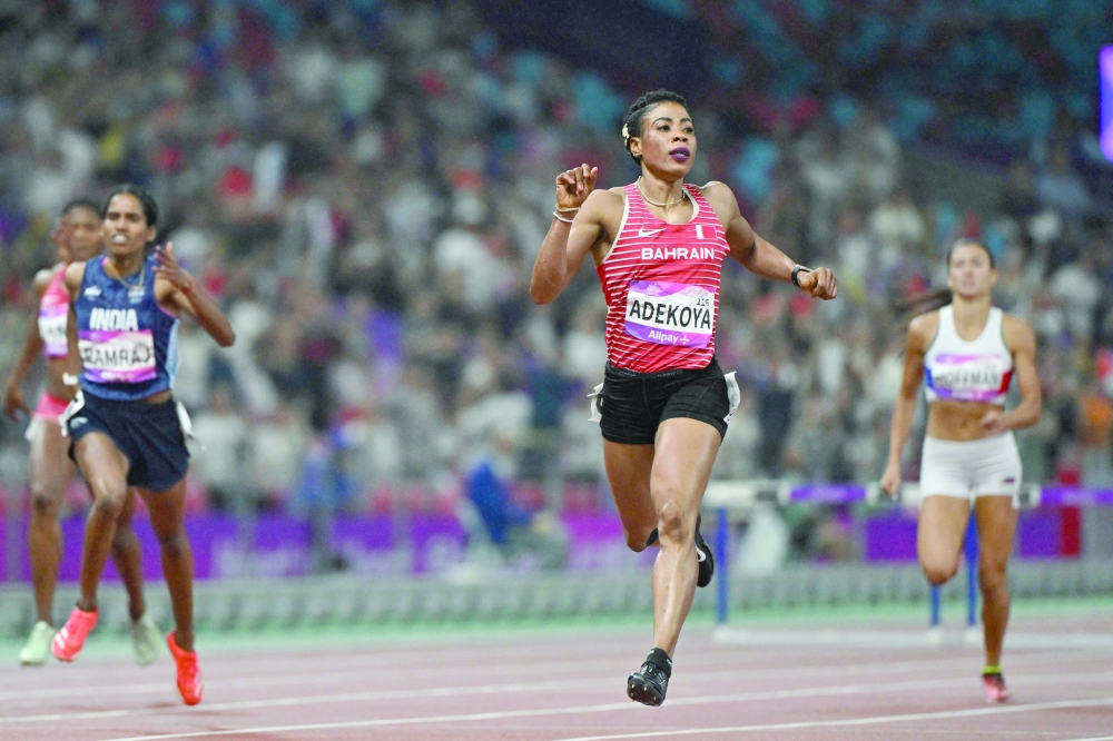 Bahrain's Kemi Adekoya crosses the finish line to win the women's 400m hurdles final athletics event during the 2022 Asian Games in Hangzhou. —AFP