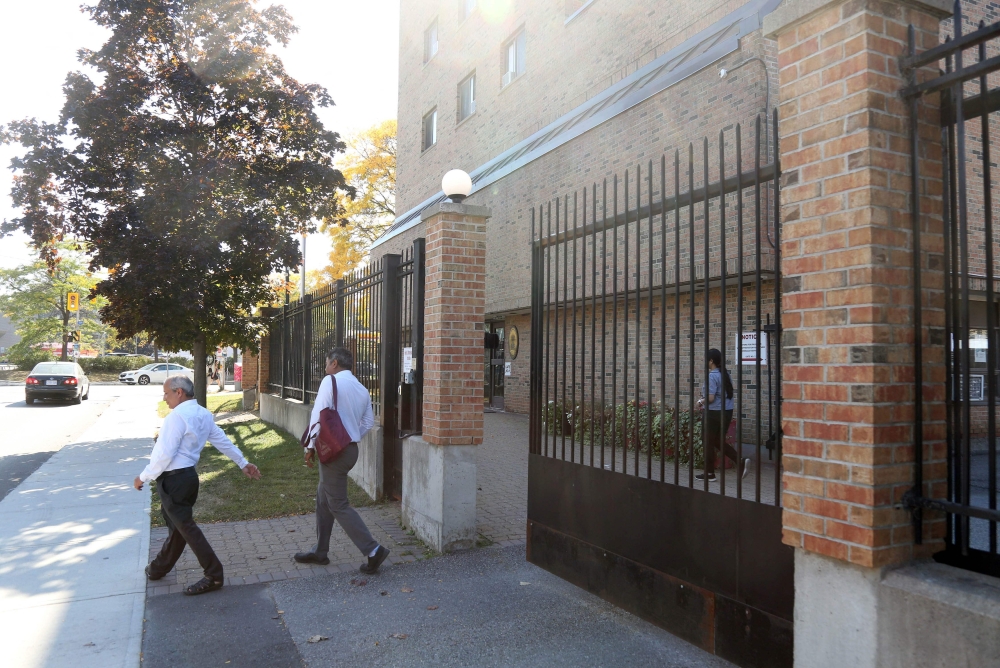 Two people exit the front gate of High Commission of India October 3, 2023 in Ottawa, 