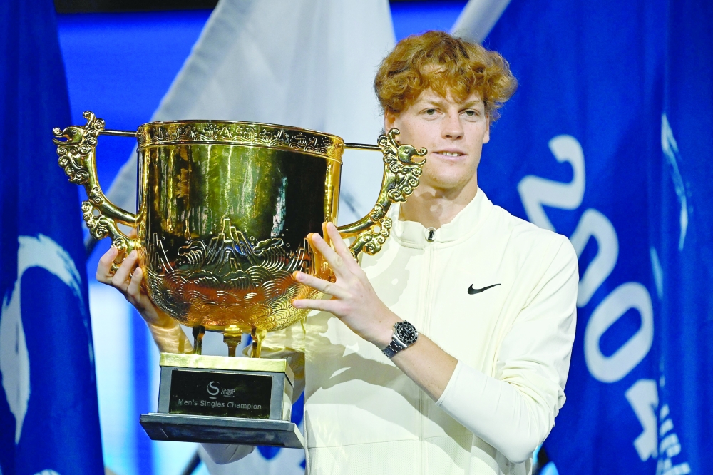 Italy's Jannik Sinner holds the winning trophy after defeating Russia's Daniil Medvedev in the final in Beijing. -- AFP