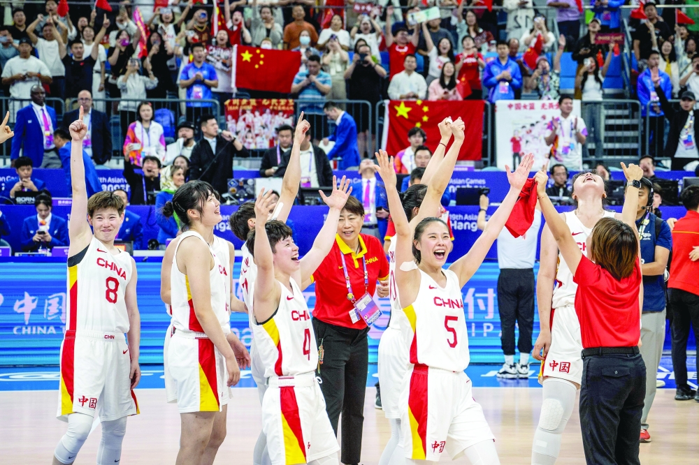 China's players celebrate their victory at the women's final basketball game between Japan and China during the Hangzhou 2022 Asian Games in Hangzhou, in China's eastern Zhejiang province on October 5, 2023.