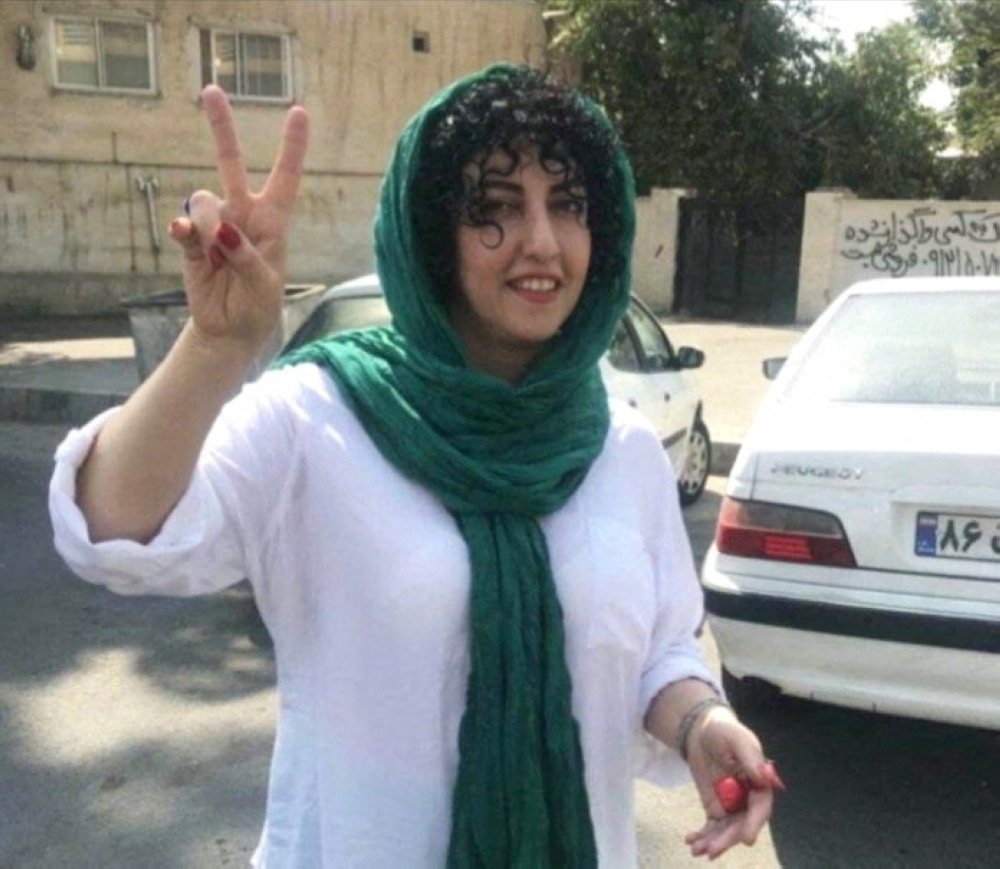 Iranian activist Narges Mohammadi, who won the Nobel Peace Prize, shows a victory sign, in an undisclosed location in Iran