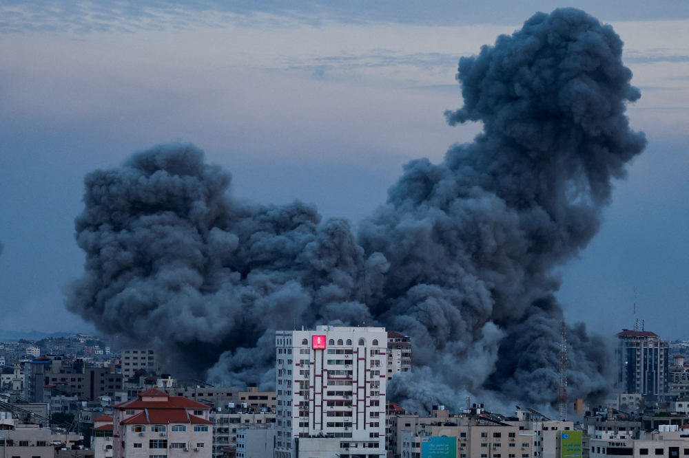 Smoke billows after forces struck a high-rise tower in Gaza City