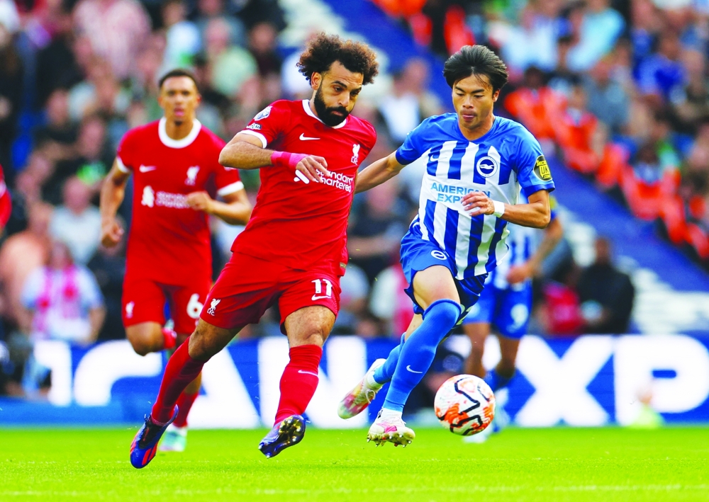 Liverpool's Mohamed Salah in action with Brighton & Hove Albion's Kaoru Mitoma.