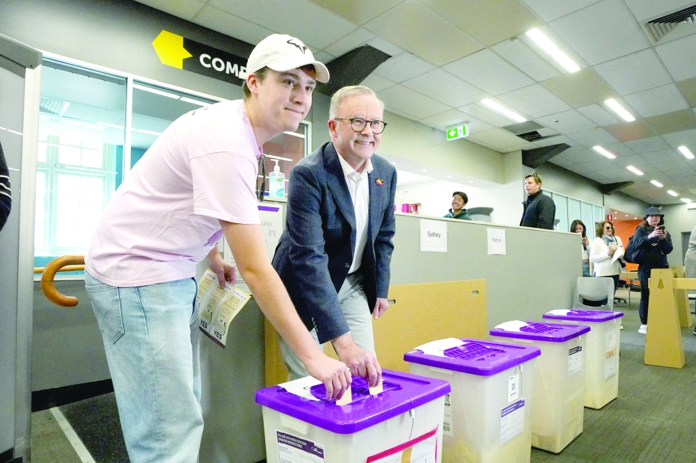 Australian Prime Minister Anthony Albanese casts his vote with his son Nathan in the referendum for an Aboriginal and Torres Strait Islander Voice to Parliament at Marrickville Town Hall in Sydney. -  Reuters
