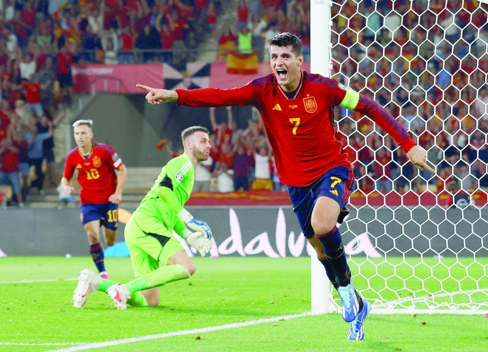 Spain's Alvaro Morata celebrates scoring their first goal against Scotland. -- Reuters