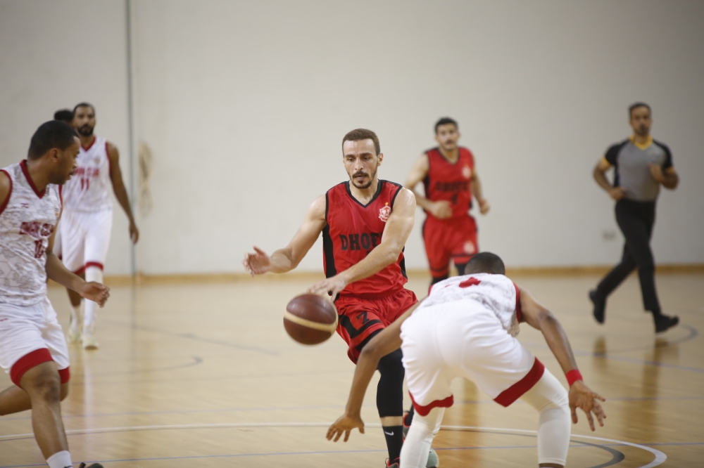 Dhofar Club player trying to bypass the opponent's defenses