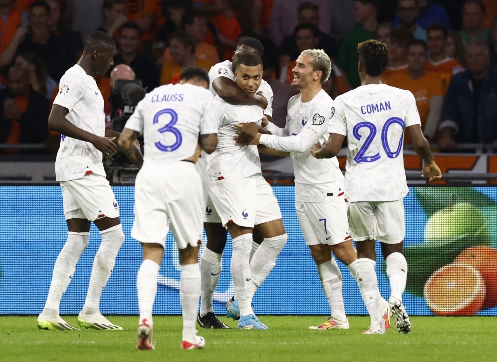 France's Kylian Mbappe celebrates scoring their second goal with teammates.— Reuters 