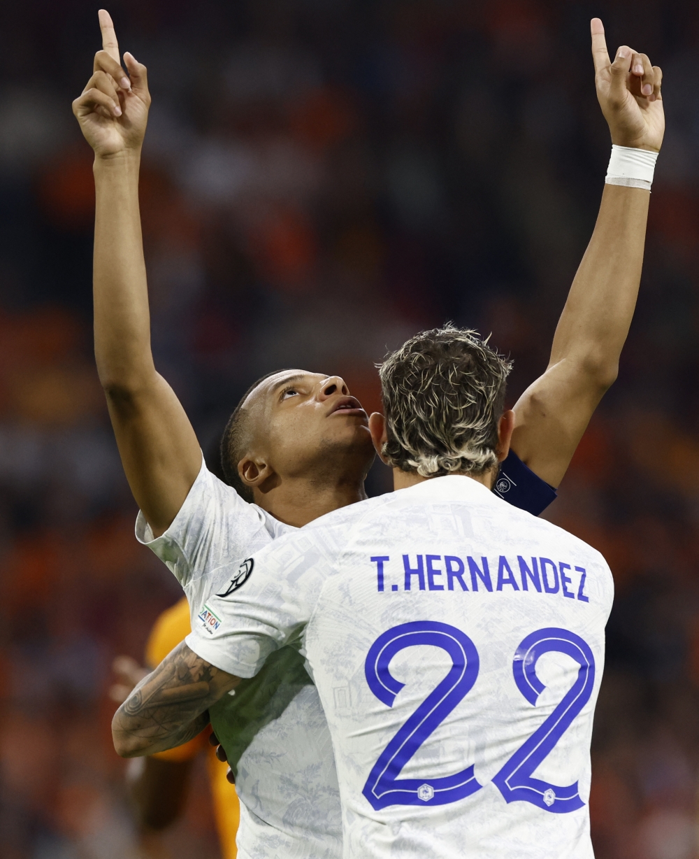 France's Kylian Mbappe celebrates scoring their first goal with Theo Hernandez.—Reuters