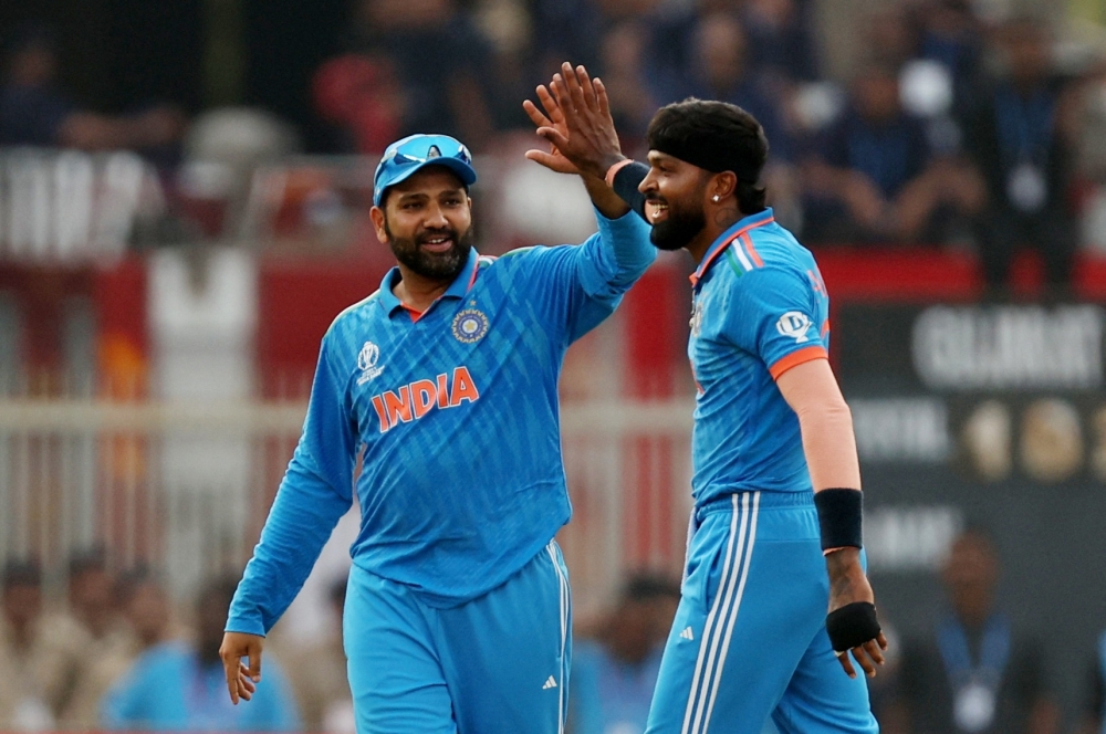 India's Hardik Pandya celebrates with Rohit Sharma after taking the wicket of Pakistan's Mohammad Nawaz.—Reuters