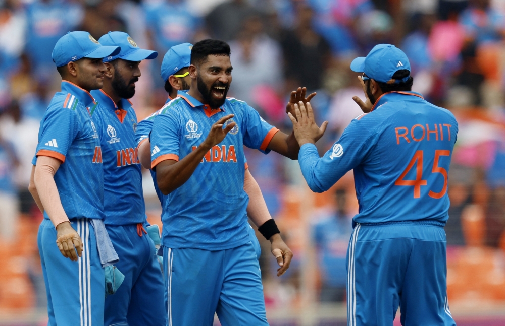 India's Mohammed Siraj celebrates with Rohit Sharma and teammates after taking the lbw wicket of Abdullah Shafique.—Reuters