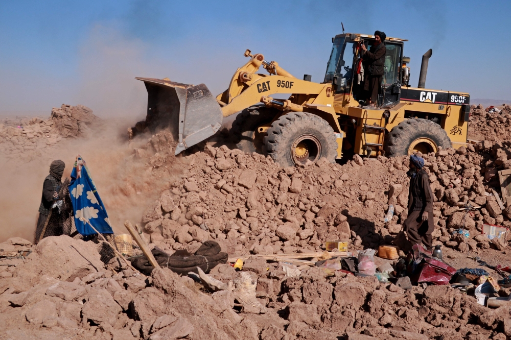han residents clear debris of damaged houses after earthquake in Nayeb Rafi village, Zendeh Jan district of Herat province