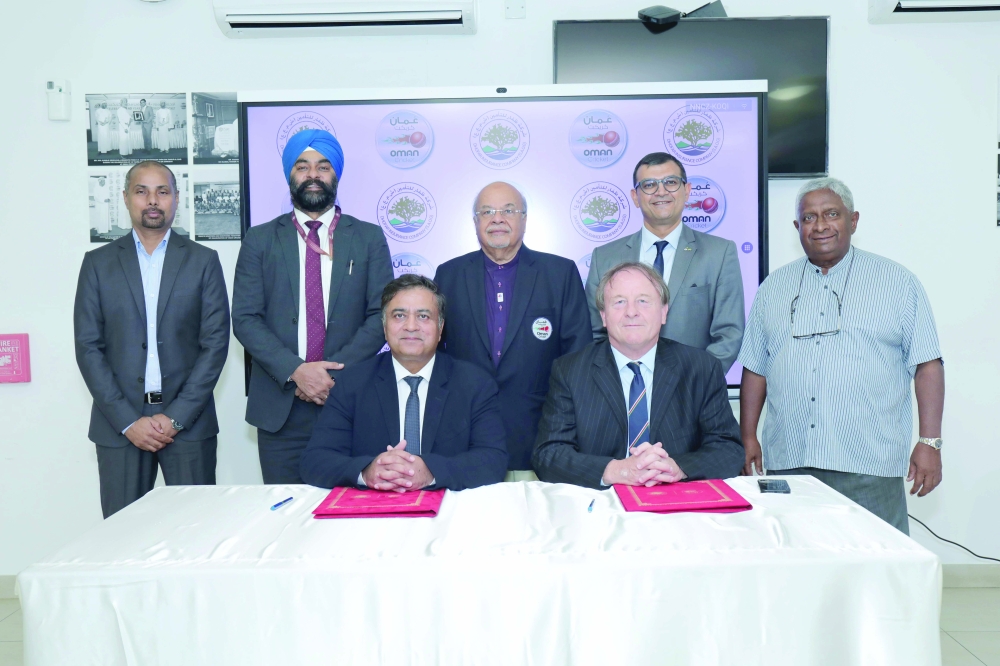 OC and Dhofar Insurance Company officials at the signing ceremony