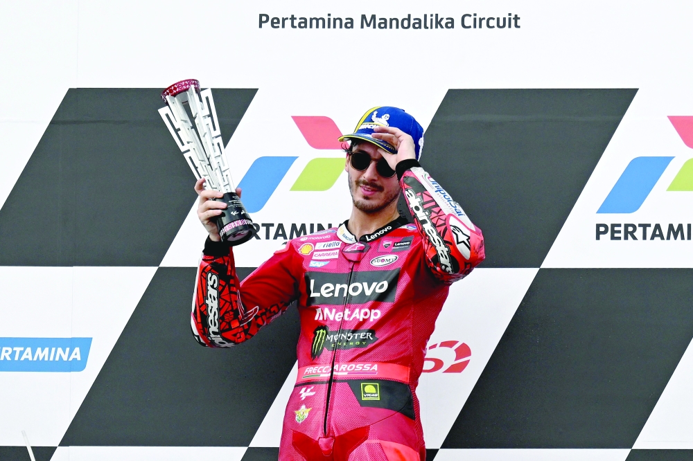  Francesco Bagnaia celebrates with the winner's trophy.— AFP

