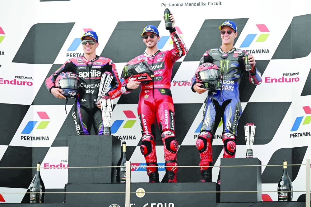  Francesco Bagnaia (C), Second-placed Maverick Vinales (L), and third-placed Fabio Quartararo celebrate during the podium ceremony.—AFP

