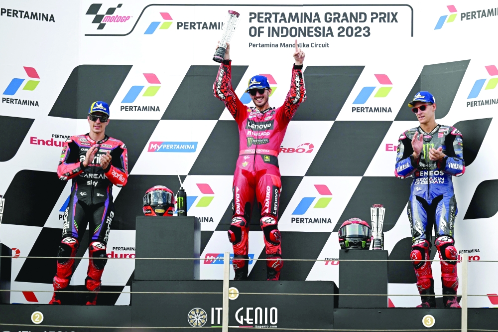  Francesco Bagnaia (C), Second-placed Maverick Vinales (L), and third-placed Fabio Quartararo celebrate during the podium ceremony.—AFP

