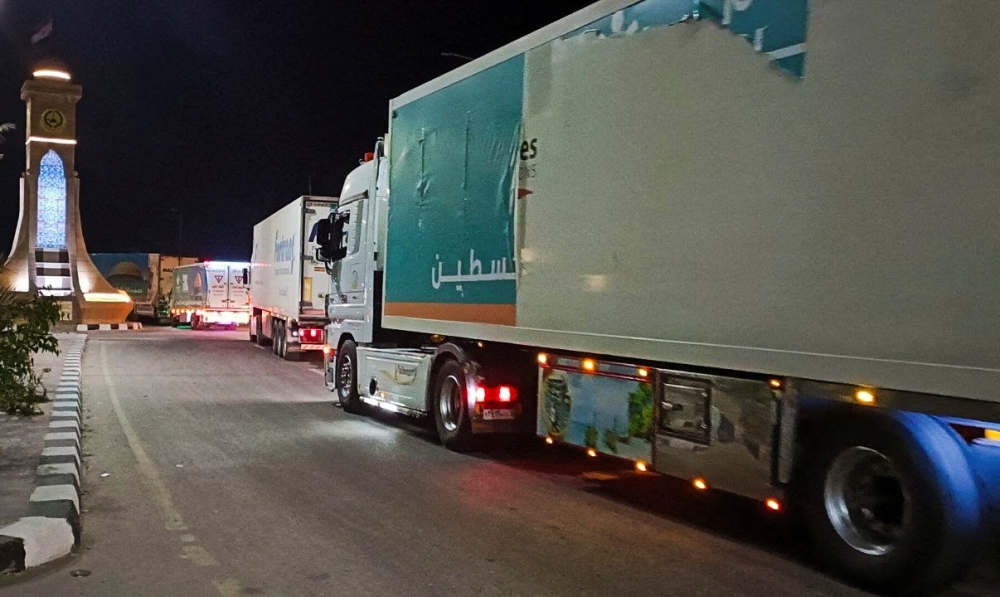 A convoy of trucks carrying humanitarian aid from Egyptian NGOs for Palestinians starts to move from Al-Arish to Rafah city as they wait for an agreement on crossing to enter Gaza,