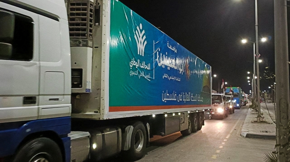 A convoy of trucks carrying humanitarian aid from Egyptian NGOs for Palestinians starts to move from Al-Arish to Rafah city as they wait for an agreement on crossing to enter Gaza,