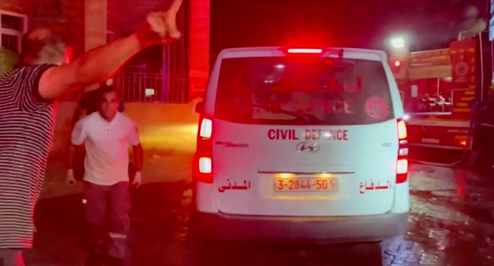 Rescue personnel work at scene At Al-Ahli Hospital, which was hit by Israeli air strike, according to Gaza Health Ministry, in Gaza City, Gaza Strip, in this screen grab obtained from video, October 17, 2023.  REUTERS/Reuters TV
