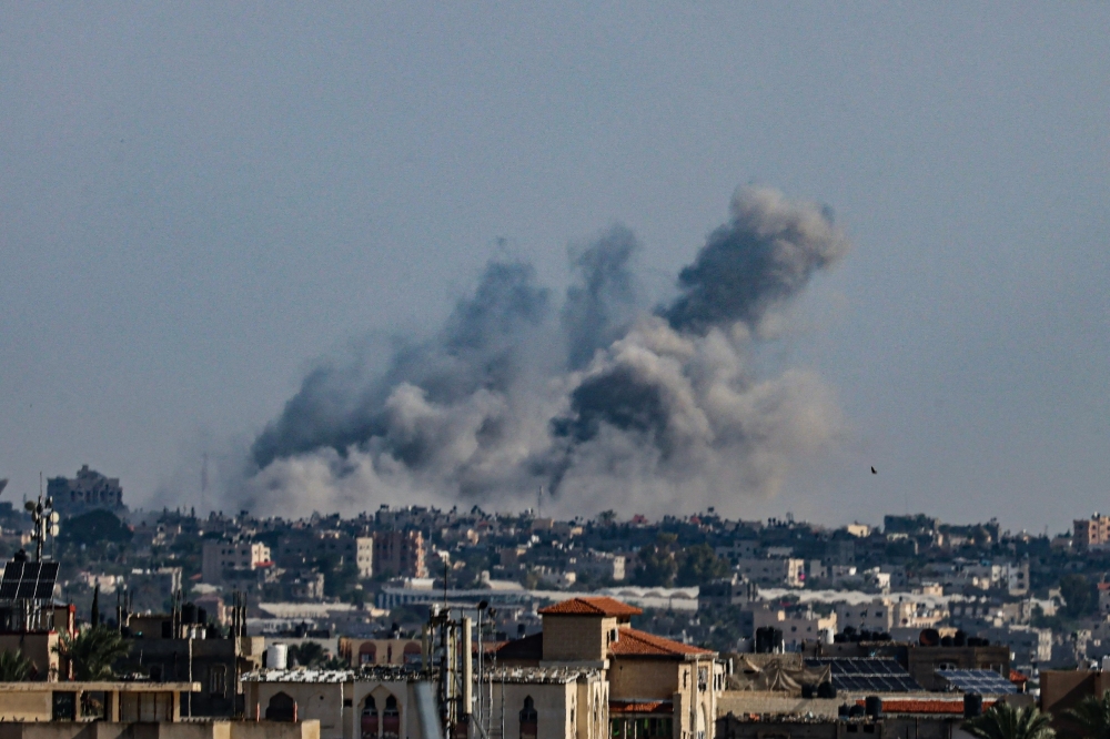 Smoke billows during Israeli bombardment of Khan Yunis in the southern Gaza Strip, on October 18, 2023