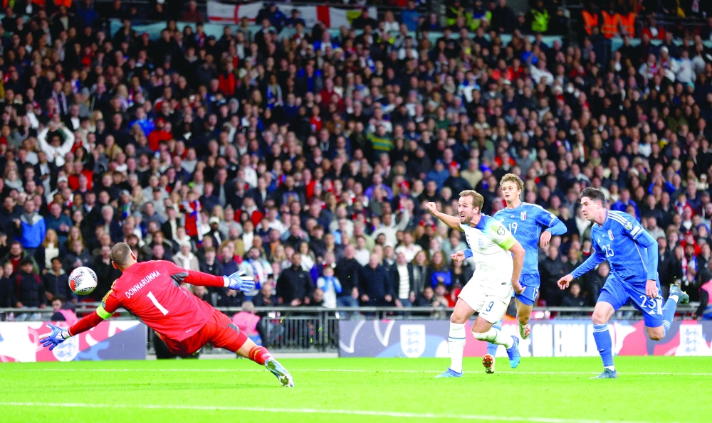 England's Harry Kane scores their third goal past Italy's Gianluigi Donnarumma. -- Reuters