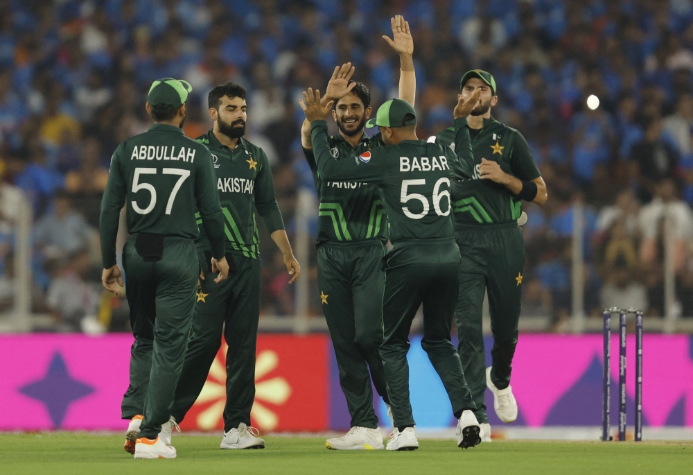 Pakistan's Hasan Ali celebrates with Babar Azam and teammates after taking the wicket of India's Virat Kohli, caught by Mohammad Nawaz. -- Reuters