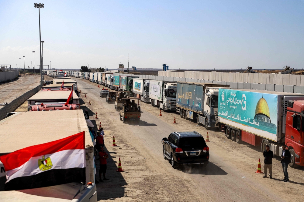 Egyptian army vehicles and a security detail escort the vehicle carrying the United Nations Secretary-General near the gate of the Egyptian side of the Rafah border crossing 