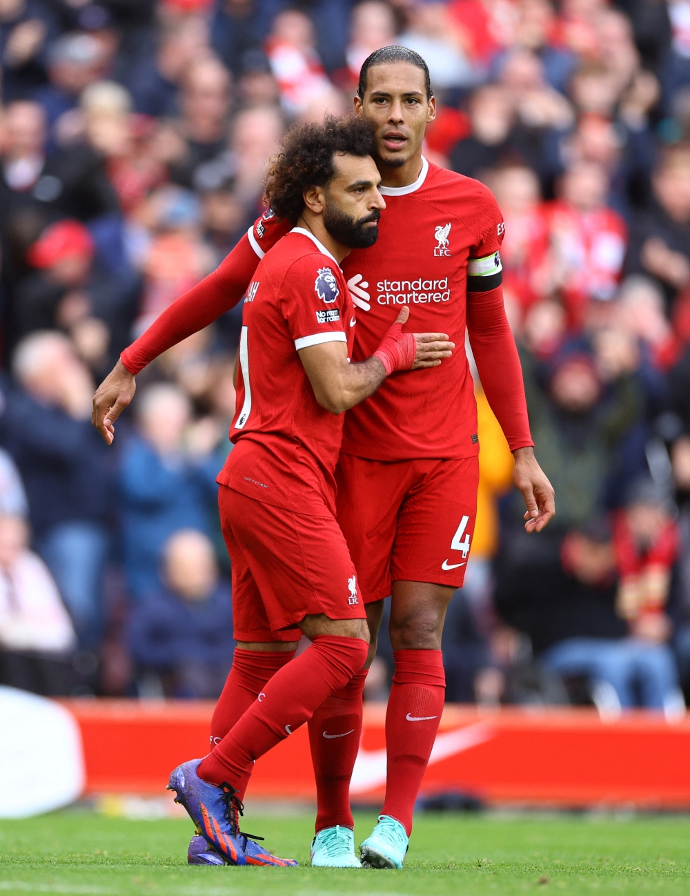 Mohamed Salah celebrates scoring their first goal with teammate Virgil van Dijk.—Reuters