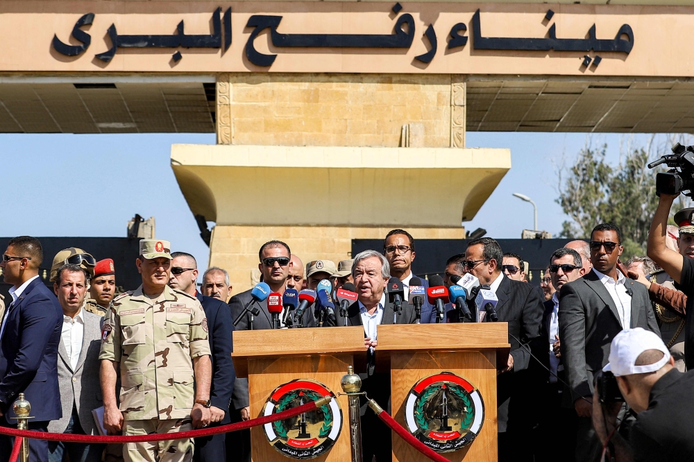 United Nations Secretary-General Antonio Guterres (C) speaks outside the gate of the Egyptian side of the Rafah border crossing with the Gaza Strip in the east of North Sinai province. — AFP 